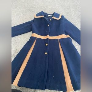 Navy pea coat with A-Line detail and tan pleating and trim